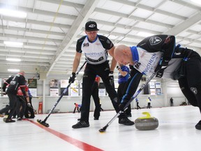 Brad Jacobs' teammates Ryan Harnden, left, watches Ryan Fry sweep during the AMJ Campbell Shorty Jenkins Classic at the Cornwall Curling Centre on Sept. 16. (Greg Peerenboom/Postmedia Network)