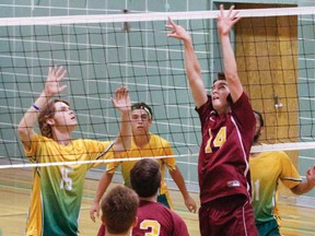 Carson Payne, of the Regiopolis-Notre Dame Panthers, sets the ball for teammate Nathan Burtch with Loyalist Lancers, Riley Prosser and Dawson Young, waiting for the spike during the first set of the Kingston Area Secondary Schools Athletic Associations senior boys volleyball game at Loyalist Collegiate, in Kingston, Ont., on Tuesday, September 20, 2016. (Julia McKay/The Whig-Standard)