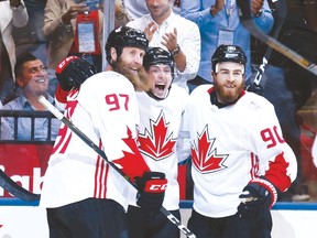Matt Duchene (centre) celebrates his first goal of the game with Joe Thornton (left) and Brent Burns during Canada’s 4-2 win over USA Tuesday night. (Michael Peake/Toronto Sun)