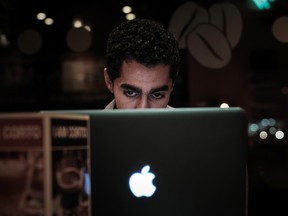 A Bahraini man browses the internet on his laptop in a coffee shop in the capital Manama on January 29, 2013. (MOHAMMED AL-SHAIKH/AFP/Getty Images)