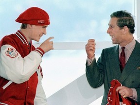 Prince William, left jokes with his father Prince Charles after being presented with a jacket and hat from the Canadian Olympic Team Uniform at a environmental heritage event in Vancouver in this 1998 file image. (THE CANADIAN PRESS/Chuck Stoody)