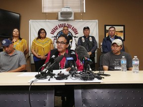 Manitoba's former aboriginal affairs minister Eric Robinson, centre, with Norway House residents Leon Swanson, left, and David Tait Jr. attend a press conference in Winnipeg last month. DNA tests have confirmed the two men were switched at birth at a hospital in northern Manitoba in 1975. (THE CANADIAN PRESS/John Woods file photo)
