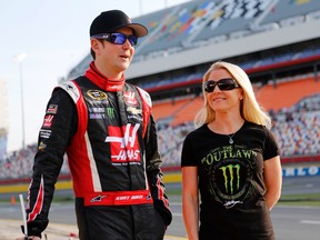 In this May 22, 2014, file photo, Kurt Busch, left, stands with Patricia Driscoll before qualifying for a NASCAR Sprint Cup series auto race at Charlotte Motor Speedway in Concord, N.C. (AP Photo/Terry Renna, File)