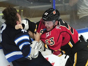 Calgary Flames' Kenney Morrison fights with Winnipeg Jets' Brendan Lemieux last Friday at the Young Stars Classic in Penticton. Lemieux, an agitator by nature on the ice, hopes to make the NHL team this season. (NICK PROCAYLO/PostMedia Network file photo)