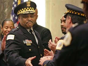 In this April 13, 2016 file photo, Chicago's police superintendent Eddie Johnson, left, shakes hands with other officers at a city council meeting in Chicago. (AP Photo/M. Spencer Green File)