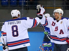 Phil Kessel of the United States celebrates with teammate Joe Pavelski after scoring his second goal in the first period against Slovenia during a men's hockey game at the Sochi Olympics on Feb. 16, 2014. (Martin Rose/Getty Images)