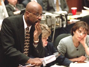 In this August 29, 1995 file photo, Deputy District Attorney Christopher Darden, left, listens to screenwriter Laura Hart McKinny concerning her interviews with Los Angeles police detective Mark Fuhrman as prosecutor Marcia Clark, right, looks on during the O.J. Simpson murder trial.(MYUNG J. CHUN/AFP/Getty Images)