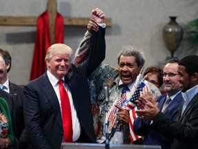 Boxing promoter Don King, right, holds up the hand of Republican presidential candidate Donald Trump during a visit to the Pastors Leadership Conference at New Spirit Revival Center, Wednesday, Sept. 21, 2016, in Cleveland, Ohio. (AP Photo/ Evan Vucci)