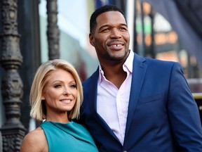 In this Oct. 12, 2015 file photo, Kelly Ripa, left, poses with Michael Strahan, her co-host on the daily television talk show "LIVE! with Kelly and Michael," during a ceremony honoring Ripa with a star on the Hollywood Walk of Fame in Los Angeles.(Chris Pizzello/Invision/AP, File)