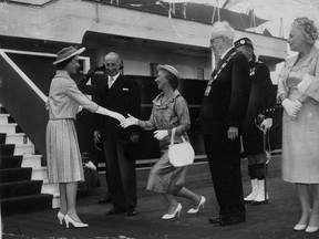 Keiller Mackay, wife of the Lieutenant Governor, curtsies daintily as the Queen comes ashore from Britannia to begin her second day's tour of Toronto in 1959. (Postmedia Network)