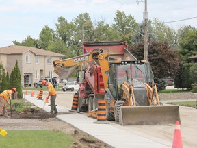 Municipal staff work on the installation of a new sidewalk on Moore Street. JONATHAN JUHA/ STRATHROY AGE DISPATCH/ POSTMEDIA NETWORK