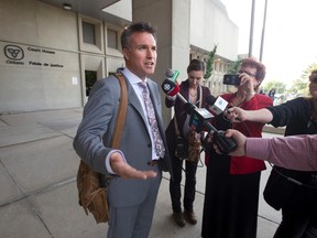 Defence lawyer Damon Hardy speaks to the media after his clients, a Korean couple who plead guilty to keeping their then 10-year-old nephew locked in a filthy bedroom for 2 years, were sentenced at the court house in London, Ont. on Wednesday. The man and woman were each sentenced to 18 months in jail and 2 years of probation. (CRAIG GLOVER, The London Free Press)