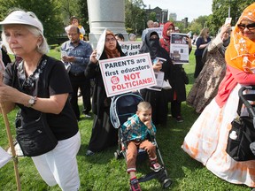 A protest at Queen's Park on Wednesday, Sept. 21, 2016, took aim at both Kathleen Wynne's Liberals and Patrick Brown's position on the new sex-ed curriculum. (Stan Behal/Toronto Sun)