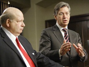 Bob Brennan, then president and CEO of Manitoba Hydro (left), looks on as Premier Gary Doer announced a power sale deal in 2008.