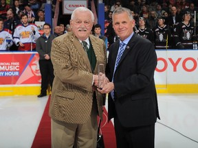 Edmonton Oil Kings scout Bob McGill, left, is presented with the WHL Distinguished Service Award by WHL commissioner Ron Robison on March 17, 2016 in Edmonton. McGill a longtime WHL scout passed away this past weekend.