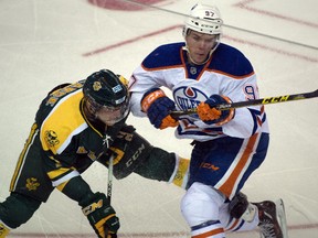 Sawyer Lange, right of the U of A Golden Bears and Connor McDavid of the Edmonton Oilers battle in the annual Oilers rookies vs Bears matchup on September 16, 2015 in Edmonton.
