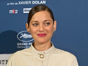 French actress Marion Cotillard poses upon her arrival at the screening of the film Juste la Fin du Monde (It's Only the End Of The World) in Paris, Thursday, Sept. 15, 2016. (AP Photo/Michel Euler)
