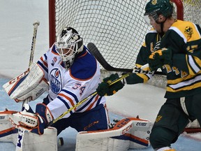 Edmonton Oilers rookie goalie Nick Ellis (34) makes the save on University of Alberta Golden Bears Jayden Hart (17) at Clare Drake Arena in Edmonton Thursday, September 21, 2016.