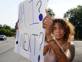 Jadah Blair holds a sign up during a demonstration Wednesday, Sept. 21, 2016 in Hagerstown, Md. Police pepper-sprayed a 15-year-old girl and charged her as a juvenile with assault and disorderly conduct after her bicycle hit a car, prompting disagreement Wednesday about whether the officers acted properly.(Ric Dugan/The Herald-Mail via AP)