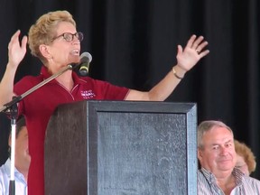 Premier Kathleen Wynne acknowledges the crowd after being booed about rising hydro rates at the International Plowing Match on Tuesday Sept. 20, 2016. (Handout/Postmedia Network)