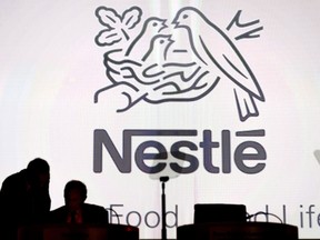 Nestle's directors speak in front of the Nestle's logo during the general meeting of the world's biggest food and beverage company, Nestle Group, in Lausanne, Switzerland, April 7, 2016. A small but fast growing Ontario community looking for a safe drinking water supply has been outbid in its attempt to buy a well by multinational giant Nestle, which acquired the site to ensure "future business growth." THE CANADIAN PRESS/Laurent Gillieron/Keystone via AP,file)