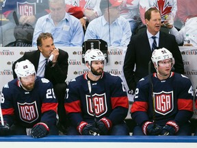 Team USA head coach John Tortorella looks on as players Blake Wheeler, Ryan Kesler and David Backes watch the game against Canada during the World Cup of Hockey in Toronto on Sept. 20, 2016. (THE CANADIAN PRESS/Nathan Denette)