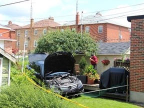 A black Mercedes in the backyard of a home on Earnscliffe Rd. on July 1, 2015. (Nick Westoll/Toronto Sun)