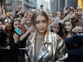 Model Gigi Hadid poses with fans outside Max Mara flagship store during the women's Spring-Summer 2017 fashion event, in Milan, Italy, Wednesday, Sept. 21, 2016. (AP Photo/Luca Bruno).
