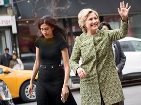 Democratic presidential candidate Hillary Clinton (R) waves as she arrives to talk with patrons at the Jackson Diner on April 11, 2016 in the Flushing neighborhood of the Queens borough of New York City. (Photo by Andrew Theodorakis/Getty Images)