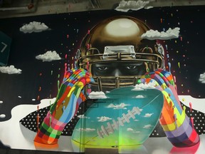 In this Tuesday, Sept. 20, 2016 photo, a mural of a football player titled "All the Way" by Chilean artist Dasic Fernandez is shown on the wall of a concourse at Hard Rock Stadium in Miami Gardens, Fla. When the Miami Dolphins play their home opener against the Cleveland Browns, it will be in a refurbished stadium that features 29,000 square feet of new, original wall art from artists from all over the world. (AP Photo/Lynne Sladky)