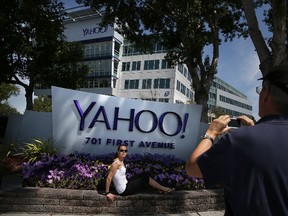 People take pictures in front of a sign that posted in outside of the Yahoo! headquarters on May 23, 2014 in Sunnyvale, California. (Photo by Justin Sullivan/Getty Images)