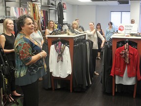 Jacquie Costron of Dress For Success (left) talks to United Way staff and workplace campaign workers on a Seeing Is Believing tour of United Way-funded agencies in Kingston on Thursday. The tour lets the workers know how the charity's money is being spent. (Michael Lea/The Whig-Standard)