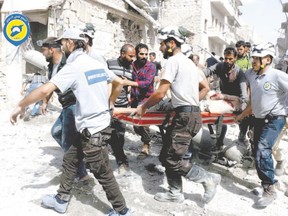 In this photo provided by the Syrian Civil Defence White Helmets, rescue workers work the site of airstrikes in the al-Sakhour neighbourhood of the rebel-held part of eastern Aleppo, Syria, Wednesday. (Syrian Civil Defense White Helmets via AP)