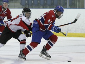 Kingston Voyageurs Cole Edwards tries to get by Stouffville Spirit Joseph Teofilo during Ontario Junior Hockey League action at the Invista Centre on Thursday. The Spirit defeated the Voyageurs 5-2. Ian MacAlpine/The Whig-Standard