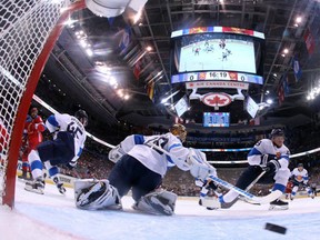 Team Russia's Vladimir Tarasenko, right, scores his team's opening goal on Team Finland's goaltender Tuukka Rask as teammates Mikko Koivu and Sami Vatanen defend during second period World Cup of Hockey action in Toronto on Thursday, Sept. 22, 2016. (Bruce Bennett/The Canadian Press via AP, Pool)