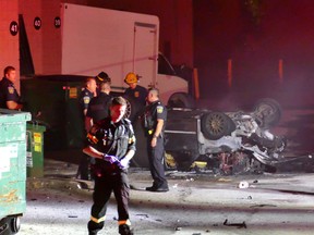 The burned remains of a car lies on its roof after a road rage incident between the driver of the car and a group of motorcyclists erupted onear Hwy. 401 and Dixie Rd. on Sept. 22, 2016. (Pascal Marchand/Toronto Sun)