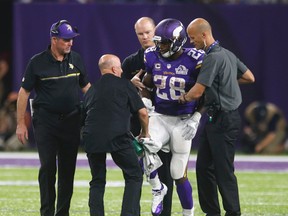 The Vikings lost running back Adrian Peterson for at least three months after he tore the meniscus in his knee. (Jim Mone/AP Photo/Files)