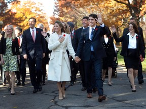 Sean Kilpatrick/THE CANADIAN PRESS
Justin Trudeau and his wife Sophie Gregoire-Trudeau walk to Rideau Hall with Trudeau's future cabinet to take part in a swearing-in ceremony in Ottawa last November.