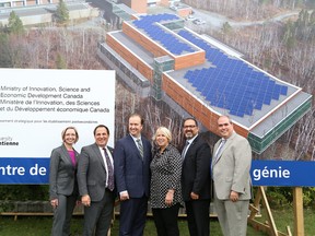 Members of government and staff from Laurentian University pose in front of the location for the newly-announced research and innovation centre. (John Lappa/The Sudbury Star)