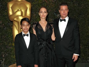 In this Nov. 16, 2013 file photo, Maddox Jolie-Pitt, from left, Angelina Jolie and Brad Pitt attend the 2013 Governors Awards in Los Angeles. (Photo by John Shearer/Invision/AP, File)