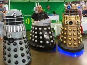 Davros (centre) aka Mark Townsend of Elora, a deadly enemy of Doctor Who, sends his daleks to "exterminate" at the London Comic Con taking place in the Progress Building at the Western Fair District in London, Ont. The two men inside the machines are Nick Ierullo of London and Steve Horst of Waterloo. (MIKE HENSEN, The London Free Press)