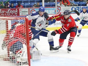 Michael Pezzetta, middle, of the Sudbury Wolves, attempts to jam the puck past goaltender Kyle Keyser, of the Oshawa Generals, during OHL action at the Sudbury Community Arena in Sudbury, Ont. on Friday September 23, 2016. John Lappa/Sudbury Star/Postmedia Network