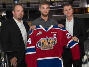 Edmonton Oil Kings head coach Steve Hamilton, left, and general manager Randy Hansch, right, introduce new captain Aaron Irving on Friday, Sept, 23, 2016 at Rogers Place.