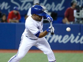 Devon Travis lays down a bunt to advance two runners for the Jays in their game with the Yankees last night. The team practised in Devon Travis T-shirts that day as a prank. (Michael Peake/Toronto Sun)