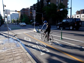 Commuters use the new cycle tracks  along 12 avenue in Calgary on June 4, 2015.