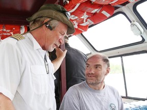 Capt. Rob Osborne, left, of the William Ramsey, chats with Corner Clinic client Mendoza Colins prior to a cruise on Ramsey Lake in Sudbury, Ont. on Friday September 23, 2016. John Lappa/Sudbury Star/Postmedia Network