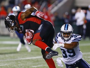 Redblacks receiver Ernest Jackson is tackled by Argonauts' Matt Black. (Errol McGihon, Ottawa Sun)