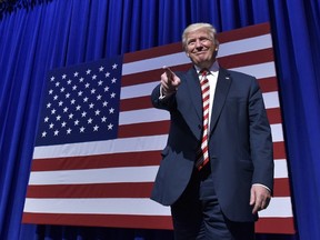 Republican presidential nominee Donald Trump arrives on stage next to a statue of Rocky during a rally at the Sun Center Studios in Aston, Pennsylvania on September 22, 2016. / AFP PHOTO / MANDEL NGANMANDEL NGAN/AFP/Getty Images