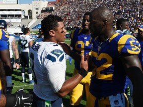 Seahawks quarterback Russell Wilson (left) and Rams outside linebacker Alec Ogletree talk after the Rams defeated the Seahawks at Los Angeles Memorial Coliseum on Sunday, Sept. 18, 2016. (Kelvin Kuo/AP Photo)