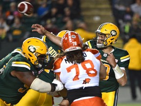 Edmonton Eskimos quarterback Mike Reilly (13) in the pocket gets off a pass against the BC Lions during CFL action at Commonwealth Stadium in Edmonton Friday, September 23, 2016.